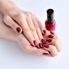 hands-of-a-woman-with-dark-red-manicure-and-nail-P5VNS4S.jpg